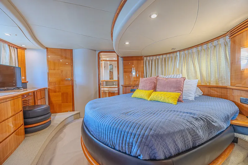 Slide: The Image of Luxurious bedroom interior of a 2008 Azimut 62 yacht with elegant wood finishes. - 51
