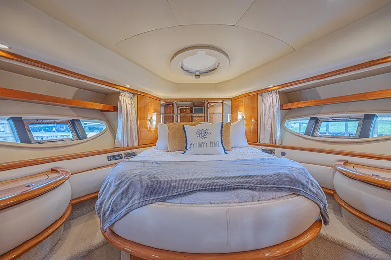 Slide: The Image of Luxurious bedroom interior of a 2008 Azimut 62 yacht with elegant wood accents. - 39