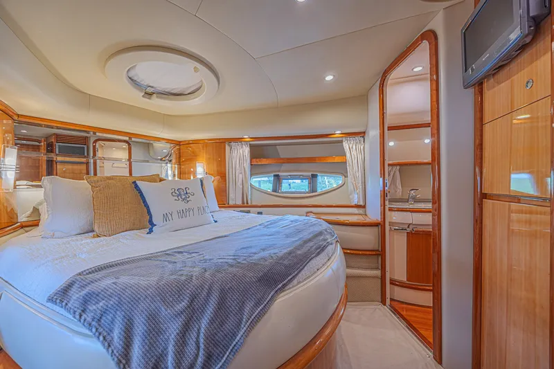 Slide: The Image of Luxurious bedroom interior of a 2008 Azimut 62 yacht with elegant wood finishes. - 38