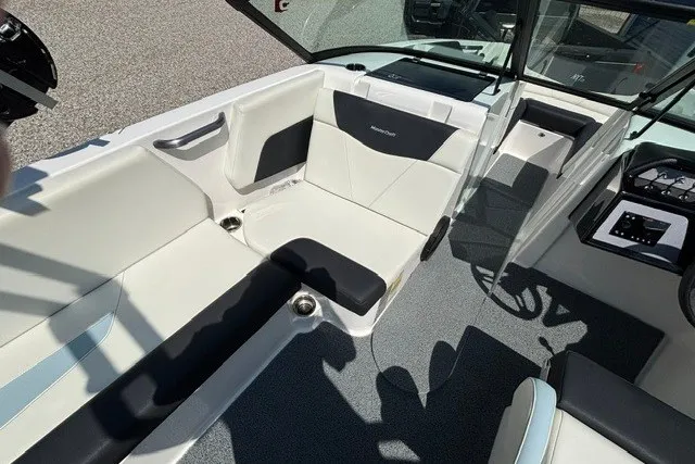 Slide: The Image of 2022 MasterCraft NXT22 boat interior with sleek seating and modern dashboard design. - 6