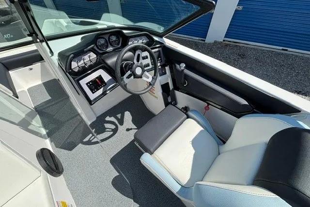 Slide: The Image of 2022 MasterCraft NXT22 boat interior with modern dashboard and comfortable seating. - 5