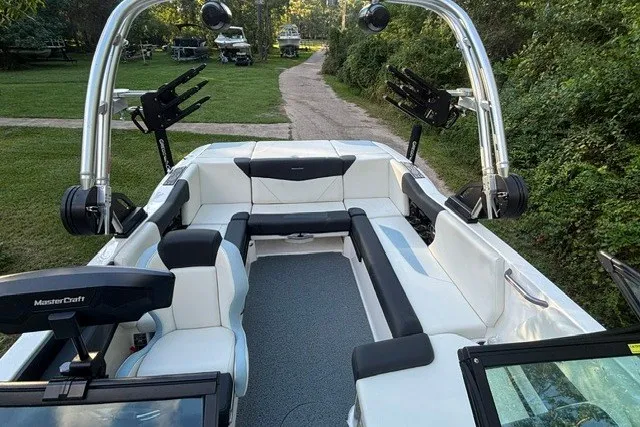 Slide: The Image of 2022 MasterCraft NXT22 boat interior with white seating and wakeboard racks. - 17
