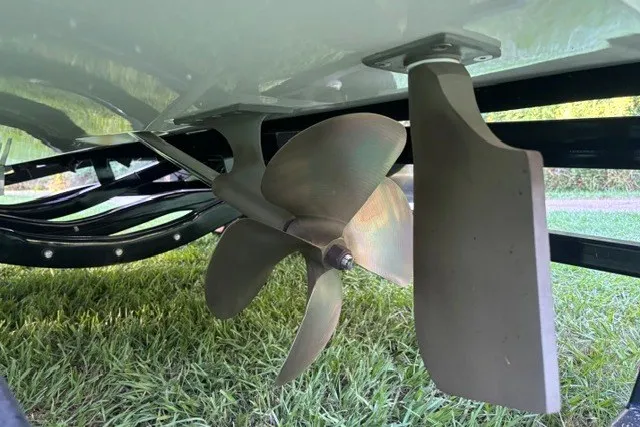 Slide: The Image of Propeller and rudder of 2022 MasterCraft NXT22 boat on grass. - 13