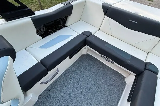 Slide: The Image of 2022 MasterCraft NXT22 boat interior with white and black seating. - 10
