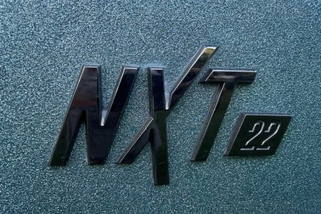 Slide: The Image of MasterCraft NXT22 2022 model logo on textured surface. - 14