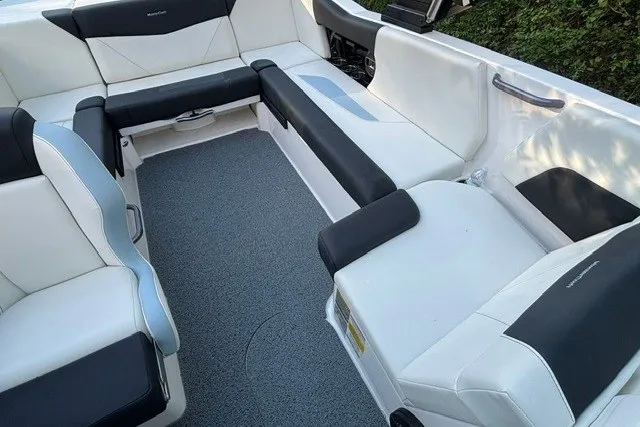 Slide: The Image of 2022 MasterCraft NXT22 boat interior with sleek white and black seating design. - 18