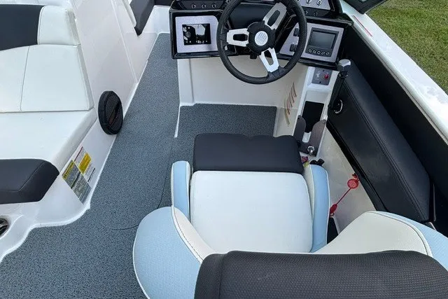 Slide: The Image of 2022 MasterCraft NXT22 boat interior with modern dashboard and comfortable seating. - 19