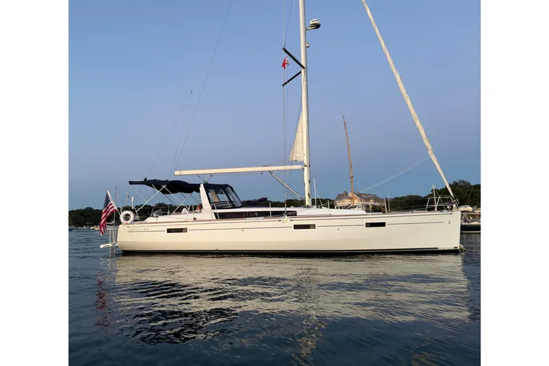The Image of 2012 Beneteau Oceanis 45 sailboat on calm water, side view. - 0