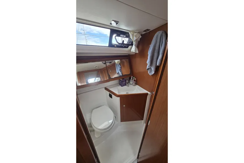 Slide: The Image of Bathroom interior of 2012 Beneteau Oceanis 45 yacht, featuring toilet and sink. - 24