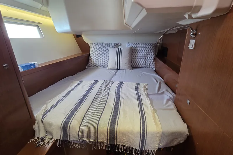 Slide: The Image of Cozy cabin interior of 2012 Beneteau Oceanis 45 yacht with striped bedding. - 22