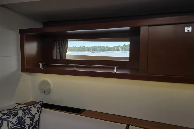 Slide: The Image of Interior view of 2012 Beneteau Oceanis 45 yacht with wooden cabinetry and window. - 14