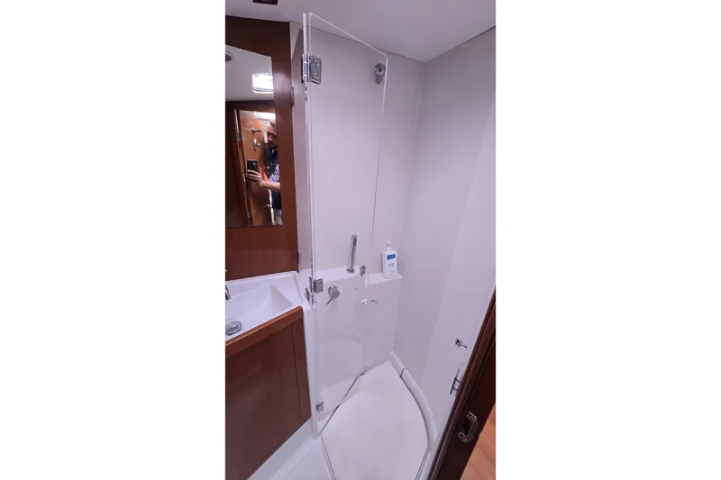 Slide: The Image of Bathroom interior of 2012 Beneteau Oceanis 45 yacht, featuring a compact shower area. - 20