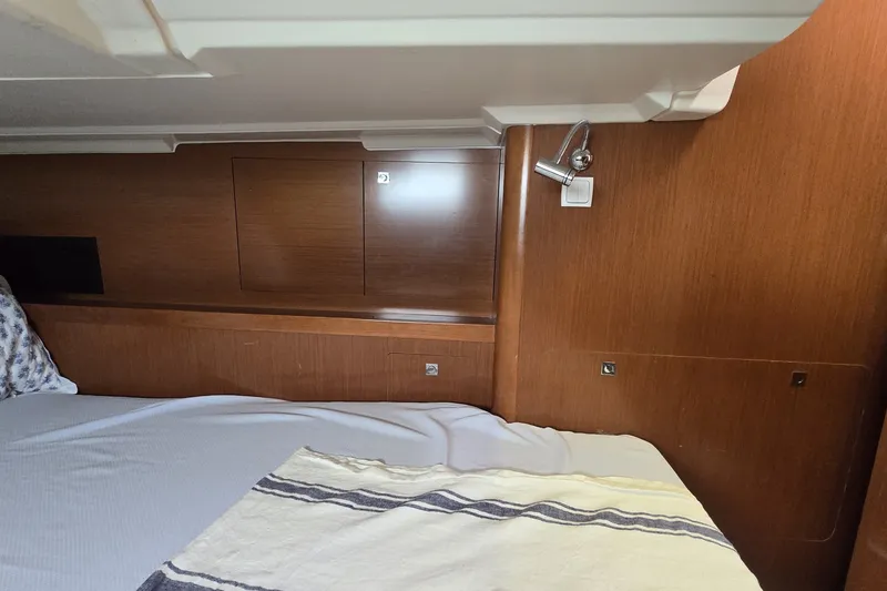 Slide: The Image of Interior cabin of 2012 Beneteau Oceanis 45 yacht with wooden paneling and bed. - 23