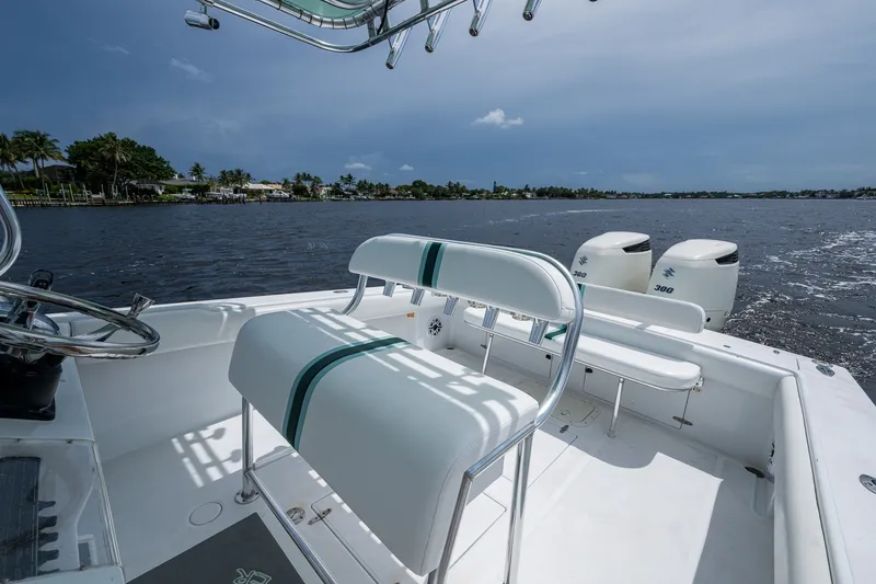 Slide: The Image of 1991 Jupiter 31 Center Console boat on water, featuring dual engines and sleek seating. - 27