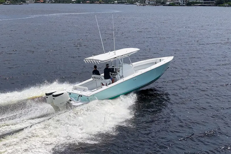 Slide: The Image of A 1991 Jupiter 31 Center Console boat cruising on open water. - 22