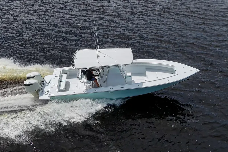 Slide: The Image of 1991 Jupiter 31 Center Console boat cruising on open water. - 16