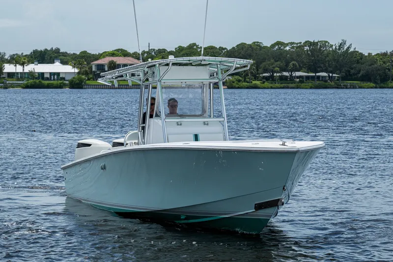 Slide: The Image of 1991 Jupiter 31 Center Console boat cruising on a calm lake. - 2