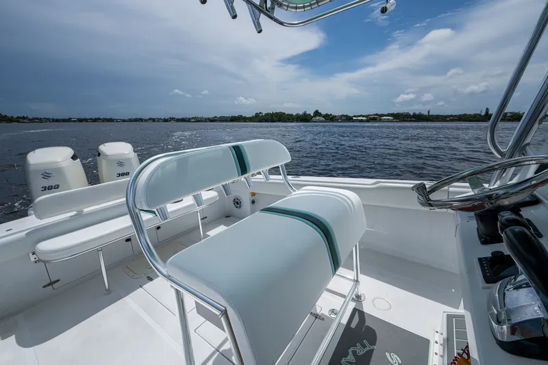 Slide: The Image of 1991 Jupiter 31 Center Console boat interior with dual engines on a sunny day. - 28