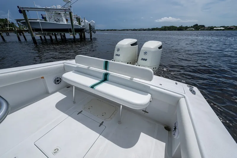Slide: The Image of 1991 Jupiter 31 Center Console boat with twin Suzuki 300 engines on a calm waterway. - 29