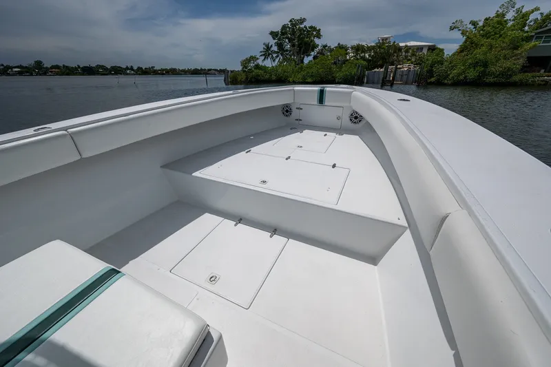 Slide: The Image of 1991 Jupiter 31 Center Console boat interior on calm water, showcasing spacious seating. - 37