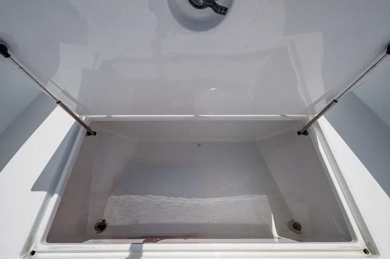 Slide: The Image of Open storage compartment on a 1991 Jupiter 31 Center Console boat. - 39