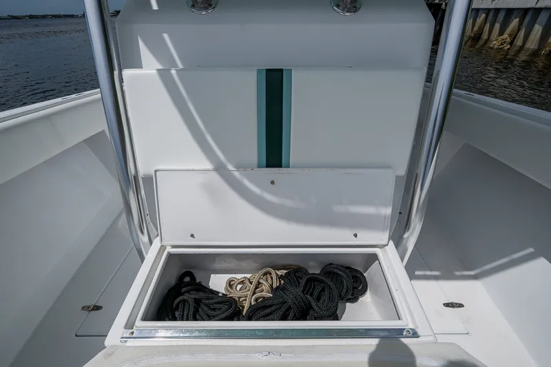 Slide: The Image of Storage compartment with ropes on a 1991 Jupiter 31 Center Console boat. - 41