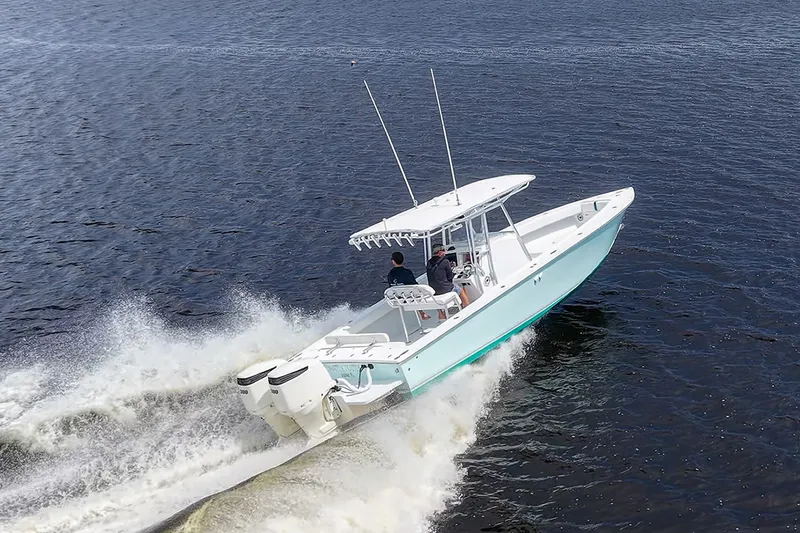 Slide: The Image of 1991 Jupiter 31 Center Console boat cruising on open water. - 14