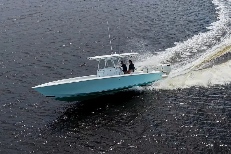 Slide: The Image of 1991 Jupiter 31 Center Console boat cruising on open water. - 17