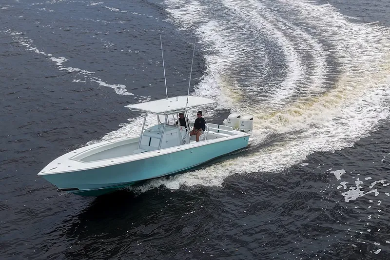 Slide: The Image of A 1991 Jupiter 31 Center Console boat cruising on open water. - 20