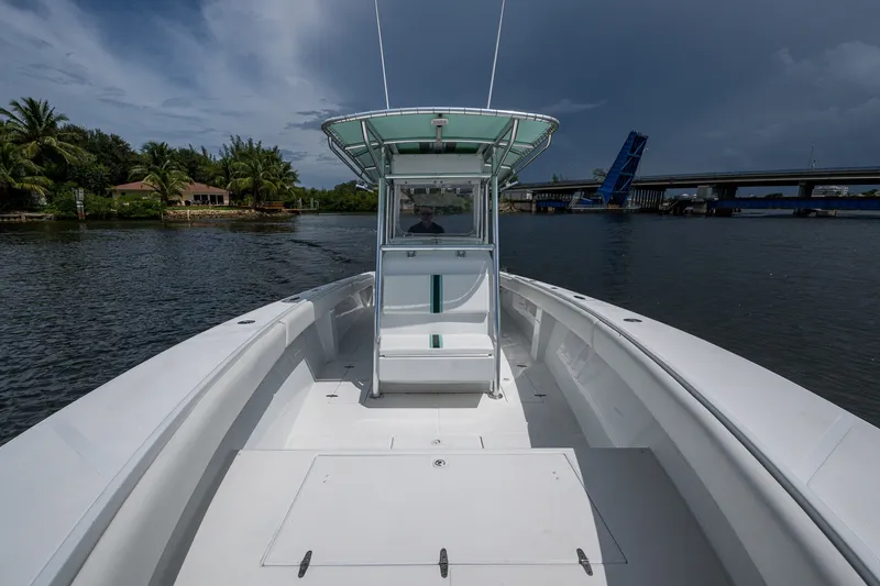 Slide: The Image of 1991 Jupiter 31 Center Console boat on water near drawbridge and palm trees. - 42