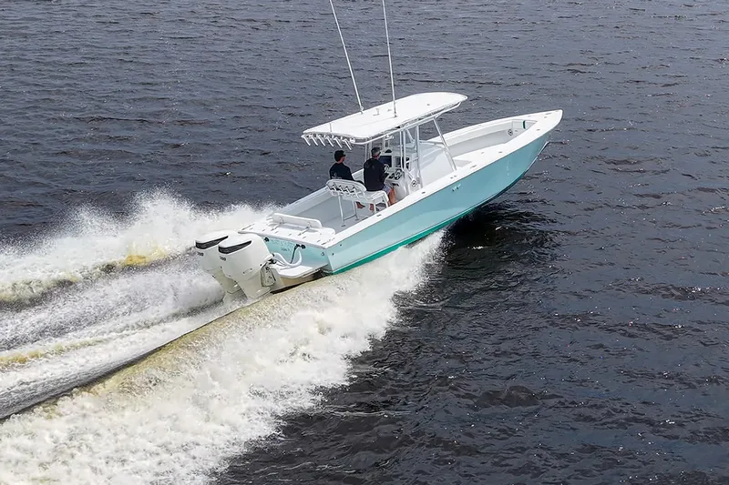 Slide: The Image of 1991 Jupiter 31 Center Console boat cruising on open water. - 13