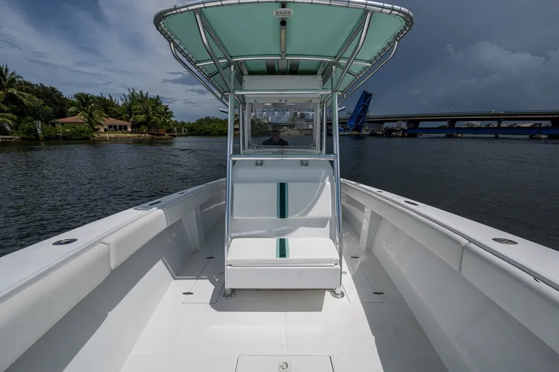 Slide: The Image of 1991 Jupiter 31 Center Console boat on calm water near a bridge. - 43