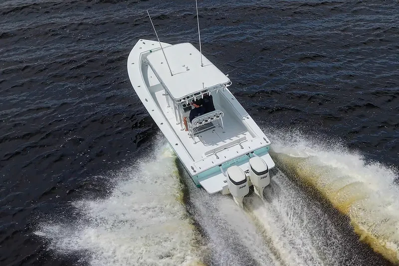 Slide: The Image of Aerial view of 1991 Jupiter 31 Center Console boat cruising on water. - 15