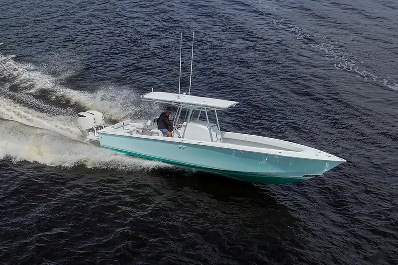 Slide: The Image of 1991 Jupiter 31 Center Console boat cruising on open water. - 19