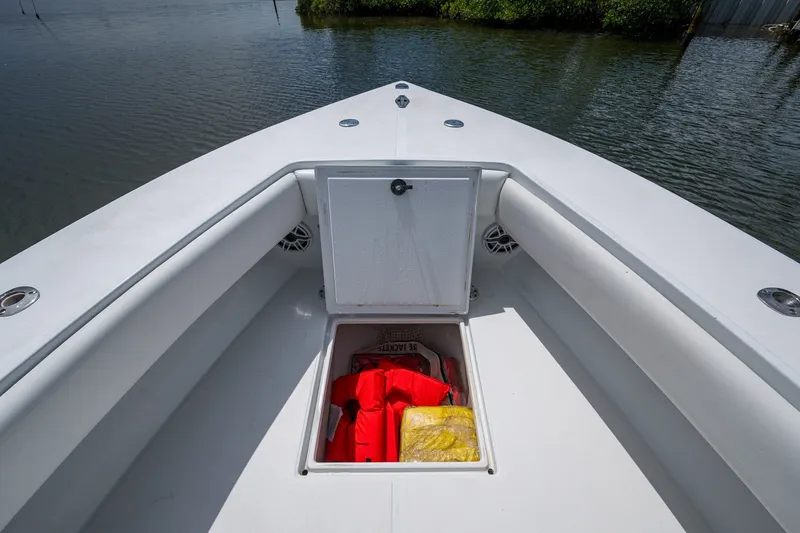 Slide: The Image of 1991 Jupiter 31 Center Console boat with open storage compartment, life jackets visible. - 38