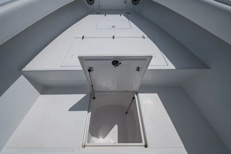 Slide: The Image of Open storage compartment on a 1991 Jupiter 31 Center Console boat deck. - 40