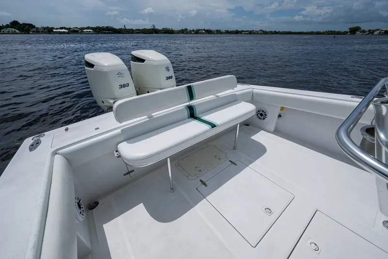 Slide: The Image of 1991 Jupiter 31 Center Console boat with dual Suzuki engines on calm water. - 35