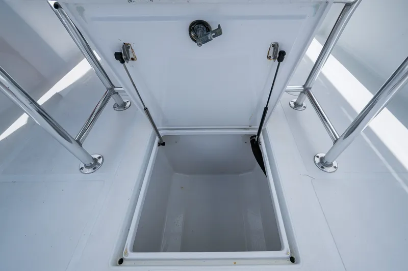 Slide: The Image of Open storage compartment on 1991 Jupiter 31 Center Console boat deck. - 32