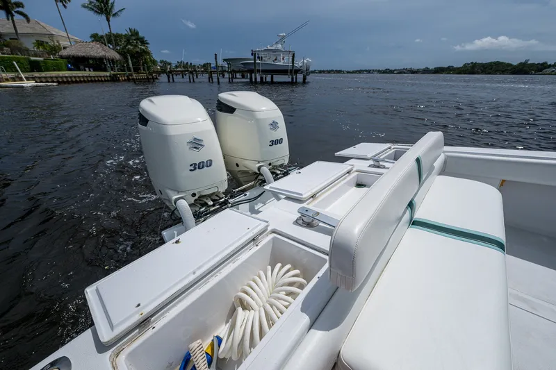 Slide: The Image of 1991 Jupiter 31 Center Console boat with twin 300 horsepower engines on a calm waterway. - 30