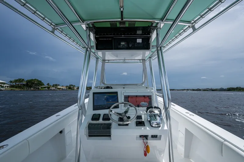 Slide: The Image of 1991 Jupiter 31 Center Console boat interior with steering wheel and navigation equipment. - 25