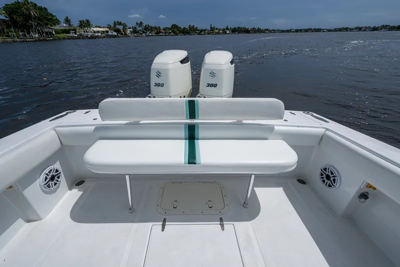Slide: The Image of 1991 Jupiter 31 Center Console boat with twin Suzuki 300 engines on a calm waterway. - 34