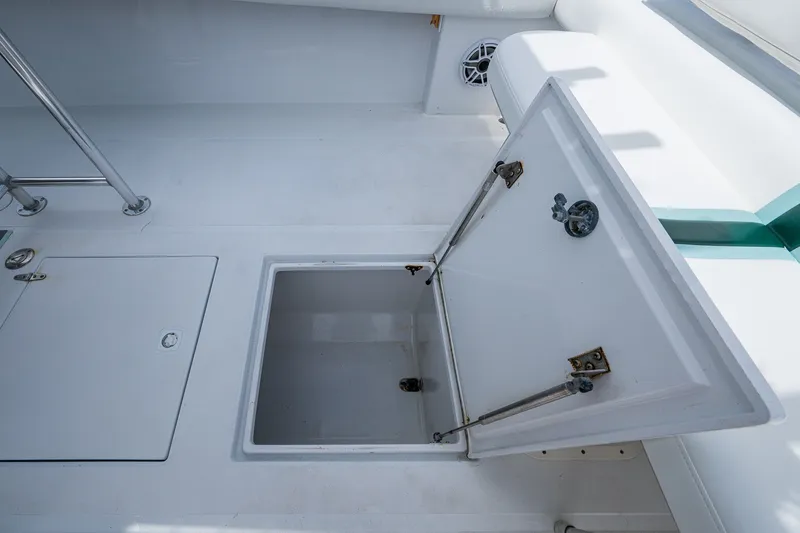 Slide: The Image of Open storage compartment on a 1991 Jupiter 31 Center Console boat deck. - 31