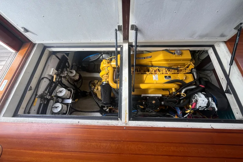 Slide: The Image of Engine compartment of a 2008 Bruckmann 50 MKII yacht, featuring a yellow John Deere engine. - 65