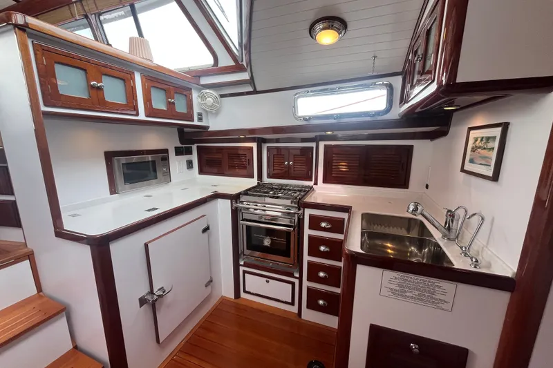 Slide: The Image of Luxurious 2008 Bruckmann 50 MKII yacht kitchen with wood cabinetry and modern appliances. - 29