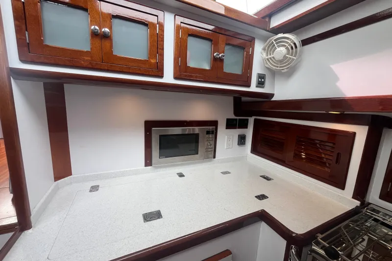 Slide: The Image of Luxurious 2008 Bruckmann 50 MKII yacht kitchen with wooden cabinets and modern appliances. - 32