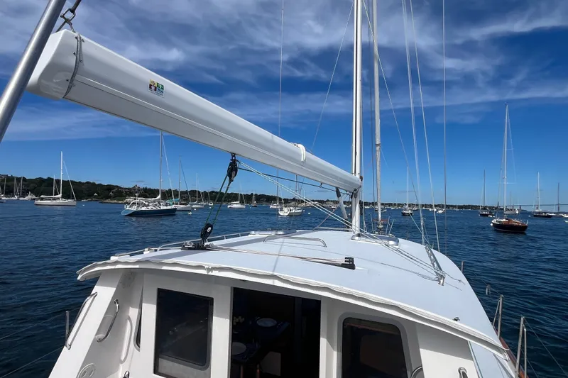 Slide: The Image of Sailboat Bruckmann 50 MKII, 2008 model, anchored in a scenic harbor with clear blue skies. - 47
