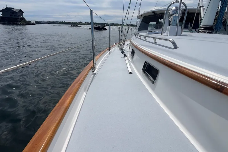 Slide: The Image of 2008 Bruckmann 50 MKII yacht deck with wooden railings on calm water. - 52