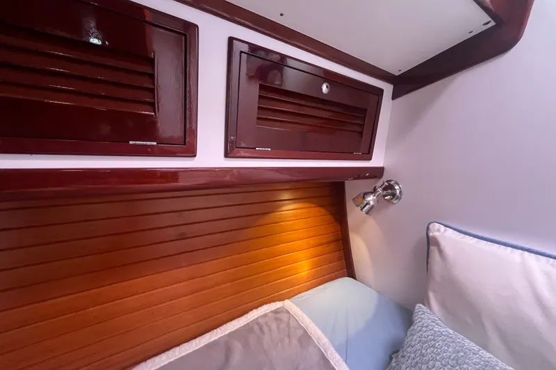 Slide: The Image of Cozy cabin interior of 2008 Bruckmann 50 MKII yacht with wooden paneling and reading light. - 18
