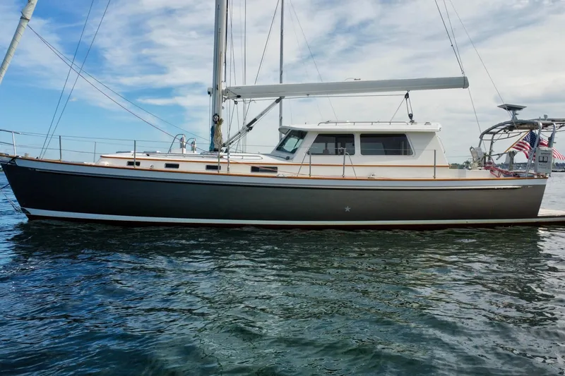 Slide: The Image of 2008 Bruckmann 50 MKII sailboat on calm water under a partly cloudy sky. - 2