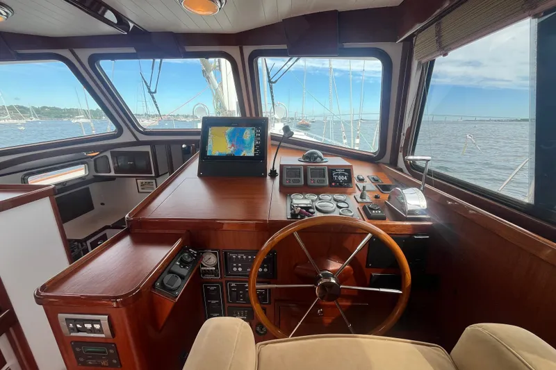 Slide: The Image of Pilothouse interior of 2008 Bruckmann 50 MKII yacht with navigation equipment and wooden steering wheel. - 37